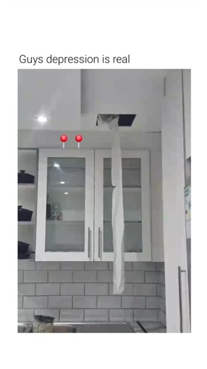 Casm Blaze on Instagram: "This video depicts a staged scenario involving a simulated self-harm attempt using common household items. The Subject: An individual is shown standing in a kitchen setting, positioning themselves beneath a hole in the ceiling where a long strip of paper or fabric is hanging. The Mechanism: The individual fashions the hanging material into a loop, places it around their neck, and leans forward to mimic the physical posture of suspension or strangulation. The Purpose: Th