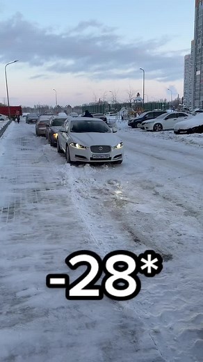 Sleek White Jaguar Car in Snowy Urban Setting