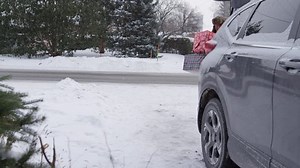 Full speed man slipping with handful of christmas gifts