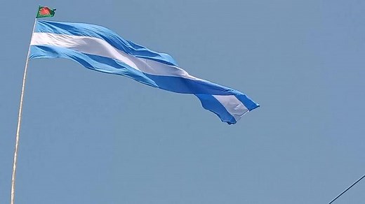 Blue and White Flag Waving in Clear Sky