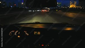 Driving on a motorway at high speeds, overtaking other cars. Super fast night drive. POV from car interior as it drives through the city streets in Istanbul