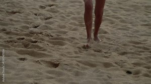 Woman legs walking on the exotic beach away from the sea during sunset. Slow motion full HD people stock footage.