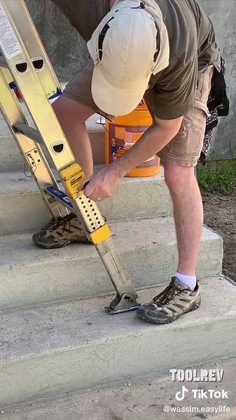 Construction Worker Using Ladder for High Reach Tasks