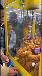 This claw machine at a store near Branson is next level: packed with fried chicken pieces AND grape soda bottles instead of toys! A group of folks are dropping quarters, fighting the claw for drumsticks, wings, and those purple grape sodas. Near-misses, big wins, cheers, groans—total arcade chaos with the ultimate combo prize. Fried chicken and grape soda for the win! | Branson Area Breaking News