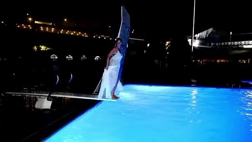 Bride Jumping Into Swimming Pool with Dress On