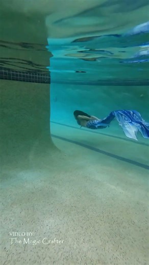 Blue dragon mermaid slithering in a pool