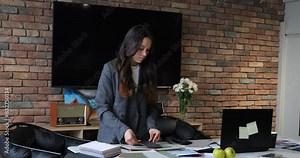 Business professional at conference reviewing material samples and discussing design strategies. Focused on collaboration and innovation, ensuring project alignment with client expectations.