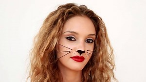 This modern black cat makeup is perfect for Halloween. More spooky makeup ideas: http://bit.ly/1jOdxJd | Real Simple