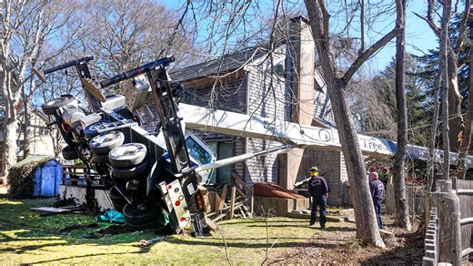 Construction crane crashes across Cape Cod property, through trees, onto Main Street