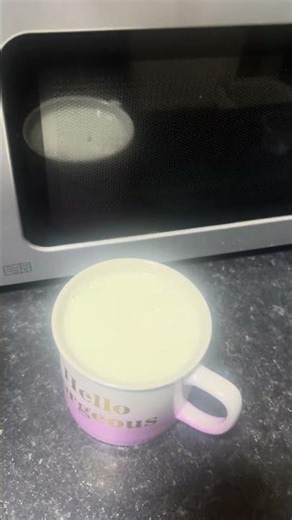 Pouring milk into a cup and putting but accidentally put a milk around the fridge