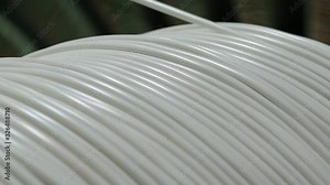 Winding cable on a rotating coil. Production of electric cable.