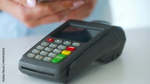 Contactless payment with smartphone. Wireless payment concept. Close-up, woman using smartphone cashless wallet NFC technology to pay order on bank terminal.