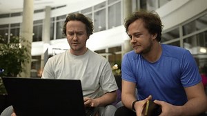 twin brothers study work together using a neural network, the brothers work with a neural network, program, work with a 3D model on a graphics tablet