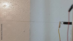 Close up: Cutting plastic foam. Automatic cutting of expanded polystyrene (foam plastic). Cutting out volumetric letters of foam plastic. Figured cutting of foam plastic.