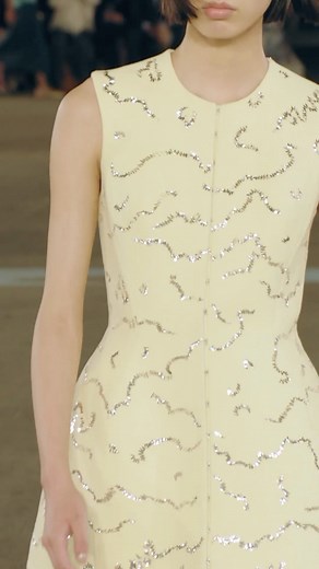 Seen on the runway: Hook-and-Eye Tunic over the Star Lace Slip Dress, Logo Flat Slingback Sandal and Serpent Cuff. #ToryBurchSS23 #ToryBurch | TORY BURCH