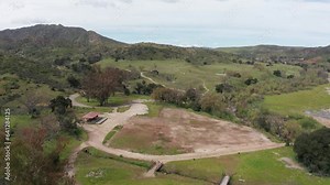 Descending close-up aerial shot of the barren patch of land where once stood the historic Paramount Ranch movie backlot, which was burned down in the 2018 Woolsey Fire. 4K