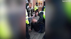 Police officer smashes young football fan in the head with a baton