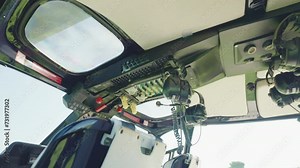 Inside view of helicopter cabin with different commands buttons and navigation instrument for secure flight, helicopter control panel and back view of pilot and passengers seats