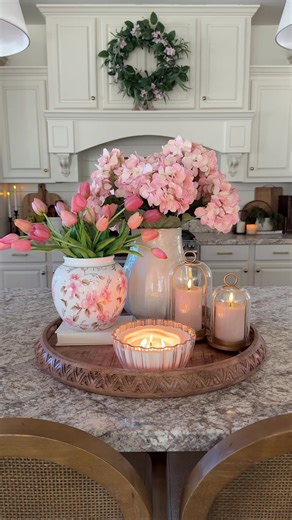 Spring centerpiece idea!🌷🌸 Using my favorite artificial flowers as usual! Tulips and hydrangeas! I also loveeee the pink floral vase! It’s perfect for spring time! I also love the gold lantern candle holders! They gave it the perfect touch of warmth and elegance!🥹🤎 I added some fluted battery candles inside of the lanterns to give it a nice cozy glow. I’m sooo ready for spring time and warmer weather! #spring #springdecor #springtime #centerpiece #springtime
