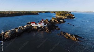 Drone appoaches the Head Harbour Lightstation in the summer, aerial footage of Campobello Island, New Brunswick, Canada