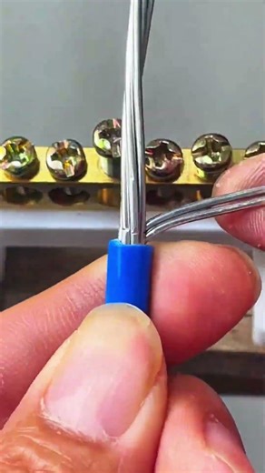 Blue wire inserted into brass terminal block