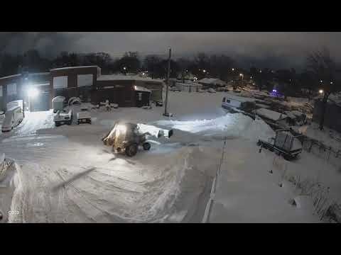 Plowing 18" of snow in a parking lot with a backhoe and a snow pusher