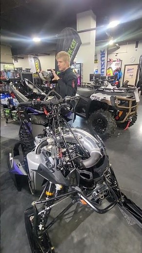 Logan at Ralphs Motorsports showing off the Arctic Cat Sled Hood Belt Storage Location.