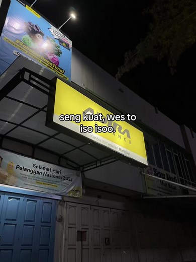 Exploring a Nighttime Scene with a Yellow Signboard