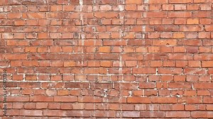 Red brick wall for background texture. Old and torn surface of brick wall