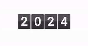 Flip the calendar going through the years from 2023 to 2024. Flip page paper.