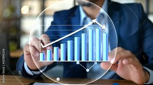 An executive pointing to a rising line graph during a meeting, illustrating the company’s journey towards financial success