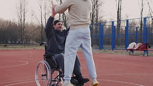 Free stock video - Young disabled man playing to basketball with his friend 1