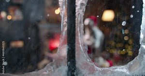 Tired Santa Claus sleeping near fireplace, holding cookies and cup with milk outside view through window. Overworked Mr Claus relaxing, sitting with legs outstretched. House of Santa, free time. Stock Video