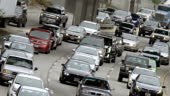 Angled view of traffic approaching, and exiting the 110 freeway,...