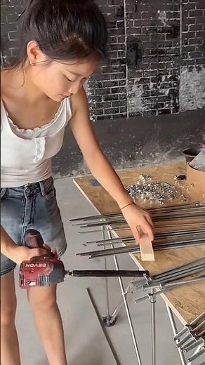 Female carpenter making suspended ceiling
