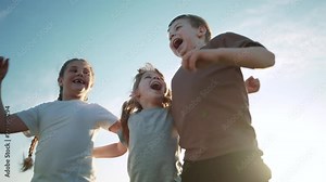 group of kids team hugging a jumping and rejoicing outdoors. happy family teamwork kid dream concept. lifestyle family children sisters brothers have fun hugging in the park in nature