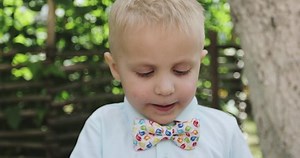 clip-1045736134-little-girl-enjoying-lollipop-while-staring-camera