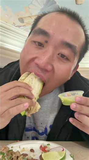 Showing and eating Super Taco from Taco Mania