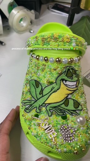 come make a pair of princess and the frog bling crics with me 💚🐸👑 one if my favorite movies! these came out so cute 😍 These crocs can be ordered by going to our site > clicking shop now> select adult custom crocs> choose your size and color and add to cart> a form will appear prompting you to customize your crocs, under theme select