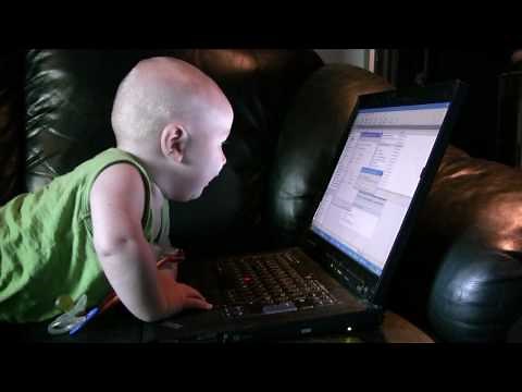 Baby encounters laptop computer for the first time
