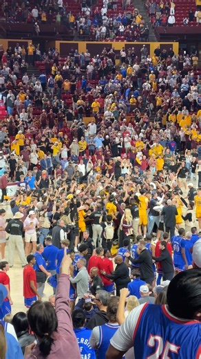 ASU fans rush the court and celebrate with the players following the Sun Devils' win vs. No. 14 Kansas. Read more: https://arizonasports.com/ncaa/arizona-state-basketball/bill-self-asu-win/3613405/ | Arizona Sports