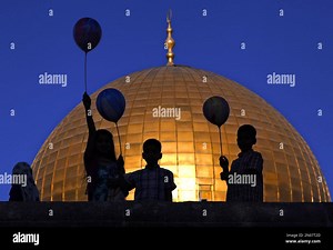 FILE - In this Thursday, Sept. 24, 2015 file photo, Palestinian children hold balloons during the Muslim holiday of Eid al-Adha, near the Dome of the Rock Mosque in the Al Aqsa Mosque compound in Jerusalem's Old City. Video surveillance of the Holy Land's most sensitive shrine was meant to be a quick fix for lowering tensions that have driven months of Israeli-Palestinian violence, but disputes over who would controls the footage and what it could show appear to be holding up the installation of
