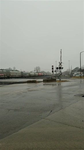 UP, NS, BNSF on this manifest powering out of Elkhart, passing the Amtrak Station on the right..
