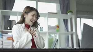 Attractive Asian businesswoman working with laptop and checking financial documents on table with calculating financial report Organize paperwork using your laptop and calculator as an aid.