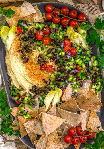 Oil Free Greek Topped Hummus! Perfect for any occasion—from holiday gatherings to casual potlucks—this colorful dip is best enjoyed with small-diced veggies and crispy, toasty pita bread triangles. . https://monkeyandmekitchenadventures.com/oil-free-greek-topped-hummus/ . #hummus #greek #potluck #oilfree #fyp