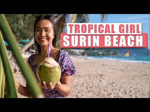 Tropical girl shows Surin Beach. Phuket, Thailand.