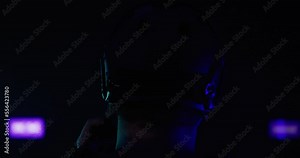 Build male putting on military helmet from behind. Clipping motion with dark, dramatic lighting for intensity and anonymity. Stock Video