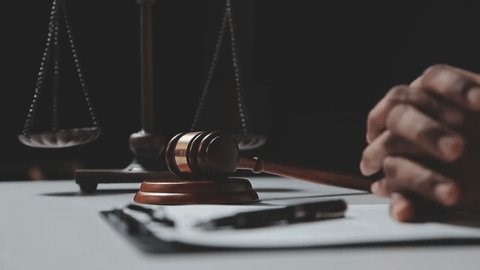 clip-3996297439-lawyer-signing-contract-pen-gavel-scales-justice