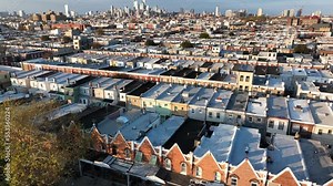 Rowhomes in USA American neighborhood ghetto. Rising aerial reveal of low income housing in America.