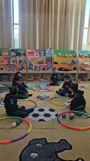 Little Einsteins School Udhampur on Instagram: "🔵🟡 Circle Ball Hunt – Teamwork in Motion! 🟢🔴 In this fun-filled Circle Ball Hunt activity, three children worked together with focus and coordination. Each child had a special role — one passed the ball from the left hula hoop to the right, the next collected and placed it into their hoop, and the last teammate gathered the balls and placed them neatly into the basket. 🎯⚽ This engaging activity kept our little learners active, alert, and happi